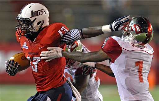 South Alabama tight end Wes Saxton, left, stiff-arms his way past Western Kentucky defensive back Jonathan Dowling in the second quarter of an NCAA college football game in Mobile, Ala., Saturday, Sept. 14, 2013. (AP Photo/G.M. Andrews)