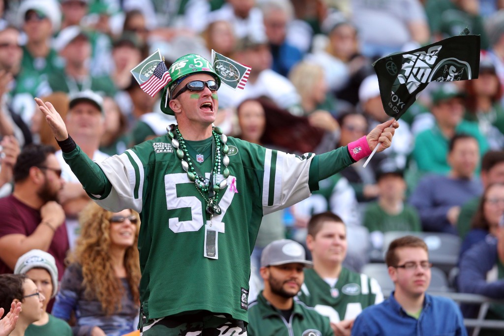 Dec 13, 2015; East Rutherford, NJ, USA; A New York Jets fan cheers during the second quarter against the Tennessee Titans at MetLife Stadium. Mandatory Credit: Brad Penner-USA TODAY Sports