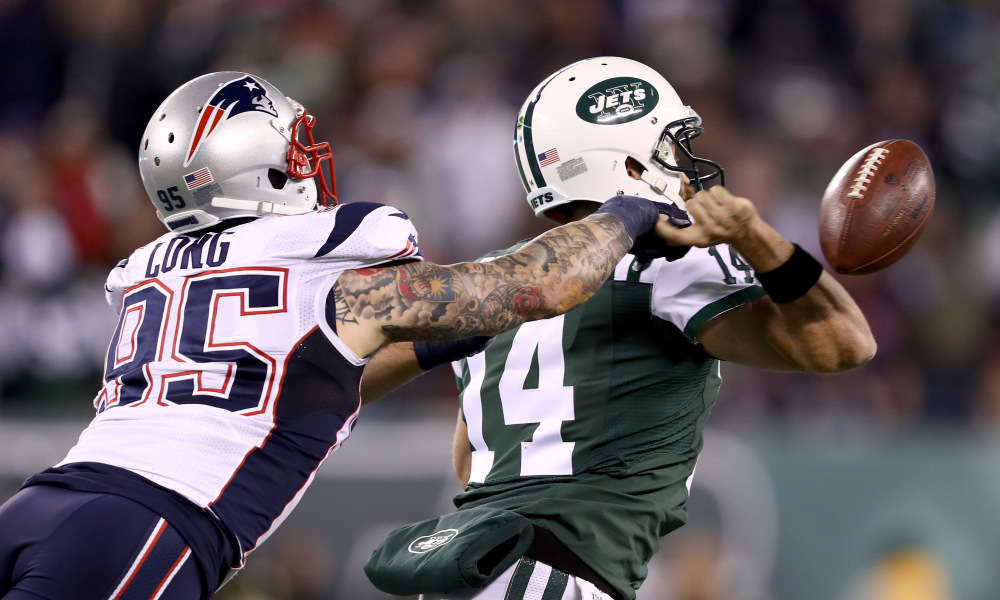 EAST RUTHERFORD, NJ - NOVEMBER 27:   Chris Long #95 of the New England Patriots knocks the ball from the hands of Ryan Fitzpatrick #14 of the New York Jets during the fourth quarter in the game at MetLife Stadium on November 27, 2016 in East Rutherford, New Jersey.  (Photo by Elsa/Getty Images)